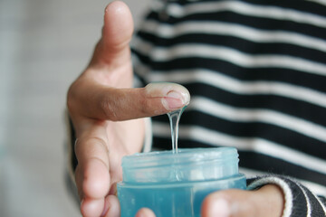hand hold a jar of hair gel,