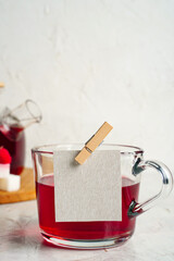 Herbal tea with red berries in a cup with copy space for text, raspberries in glass teapot. Honey Medicine tea for cold. Vitamin tea drink Rustic style