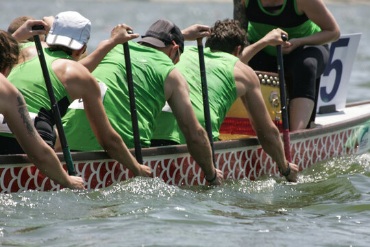 people paddle a dragon boat
