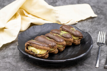 Chocolate eclair cake on dark background. World cuisine delicacies. close up