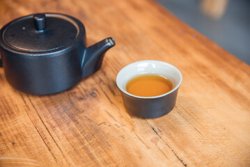 Cup and tea set with tea on table