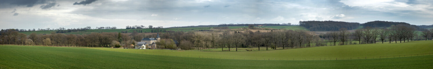 Hills of Limburg Netherlands near Gulpen. Spring. Winding road. Panorama with Neuborg castle.