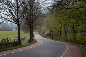 Fototapeta na wymiar Hills of Limburg Netherlands near Gulpen. Spring. Winding road.