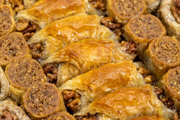 Walnut baklava. Varieties of baklava with walnuts in a tray. Traditional Turkish cuisine delicacies. Close-up baklava background.