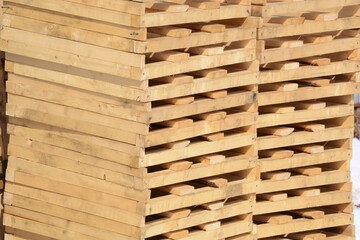 Wooden pallets piled up in a warehouse.