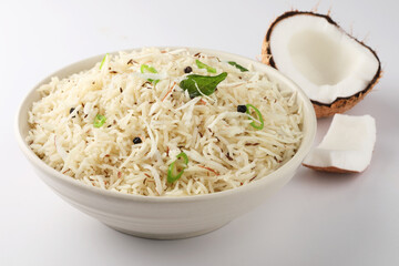 Coconut Rice is a popular South Indian food, served in a ceramic bowl. selective focus