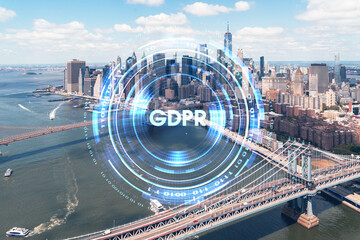 Aerial panoramic city view of Lower Manhattan. Brooklyn and Manhattan bridges over East River, New York, USA. GDPR hologram, concept of data protection regulation and privacy for all individuals