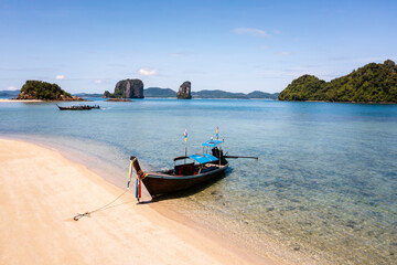 Naklejka na ściany i meble Thai traditional wooden longtail boat on ther sand Beach in Krabi province. Thailand.