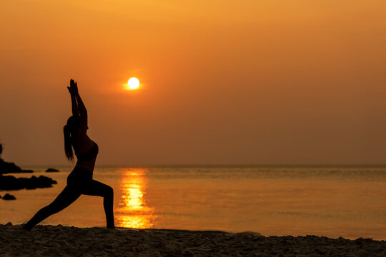 Lifestyle woman yoga exercise and pose for healthy life. Young girl or people pose balance body vital zen and meditation for workout silhouette sunset beach and sea background. Healthy Concept © freebird7977