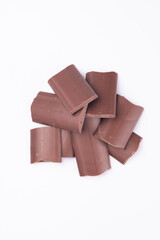 milk chocolate kibbles, pieces top view close up isolated on white background