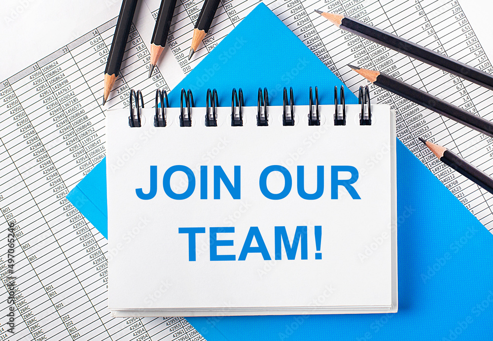 Poster white notebook with the text join our team on the table next to black pencils on a blue background a