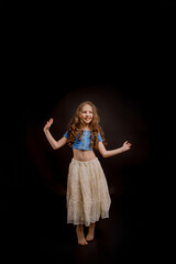 girl dressed in an outfit for dancing, on a black background