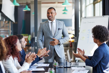 His speech has made a huge impact on his team. Shot of a group of businesspeople applauding during...