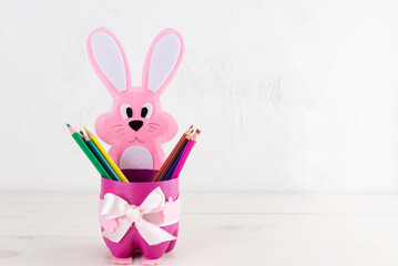 Pink rabbit with pencils from a plastic bottle. The second life of old things.