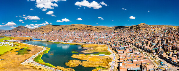 Aerial panorama of Puno with Lake Titicaca in Peru, South America