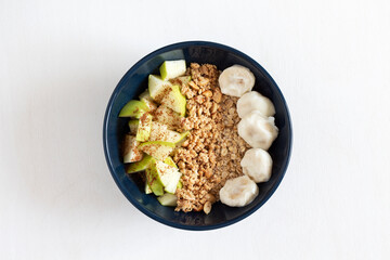 Oatmeal with apples, cinnamon, peanut butter and bananas in yogurt for breakfast