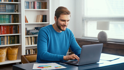 Male professional typing on laptop keyboard