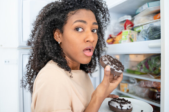 One Black Woman Snacking Tempted By Sugar Sweeties