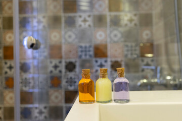 Small, colored shampoo bottles. Selective focus.