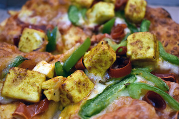 Pizza or paneer pizza served in wooden pan. Selective focus