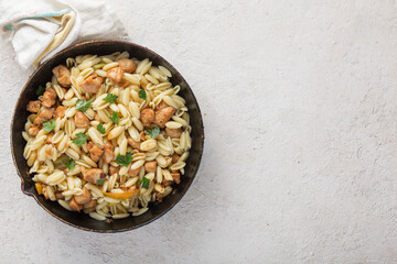 Gnocchi pasta with meat close-up in a pan. Italian cooking