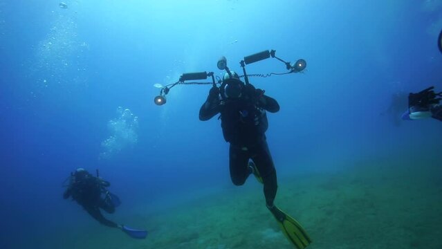 Under the sea divers, underwater exploration with equipment.