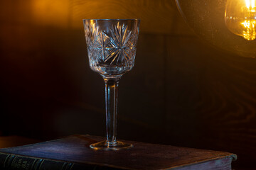Crystal glasses are lit by a nightlight.Light and reflections from crystal.