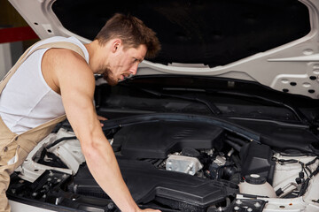 Close Up Shot of a Professional Mechanic Working on Vehicle in Car Service.