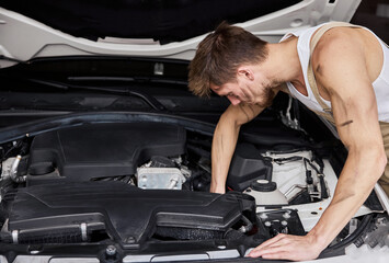 Close Up Shot of a Professional Mechanic Working on Vehicle in Car Service.