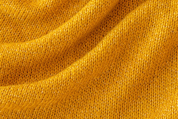 Soft knitted yellow sweater texture closeup. Light orange abstract background. Trendy soft mustard-colored backdrop for web design. Luxury twisted fabric backplate 