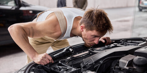 Close Up Shot of a Professional Mechanic Working on Vehicle in Car Service.