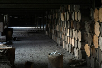wooden barrels stacked in old abandoned industry building