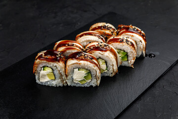 Japanese cuisine. Rolls on a dark concrete background
