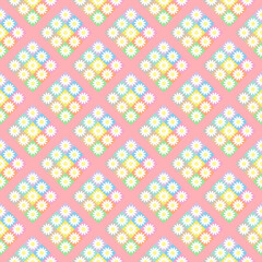 Seamless background with multicolored floral patterns on pink background.
