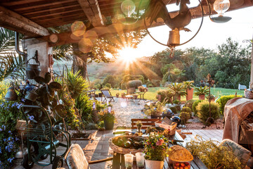beautiful italian terrace with view on a magical garden during sunset