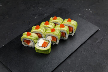 Japanese cuisine. Rolls on a dark concrete background
