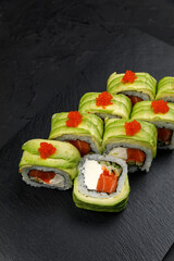 Japanese cuisine. Rolls on a dark concrete background
