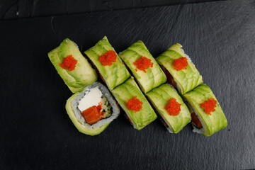 Japanese cuisine. Rolls on a dark concrete background
