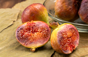 Freshly ripe figs. Healthy Mediterranean fig fruit. Fresh figs on a dark background. Beautiful blue...
