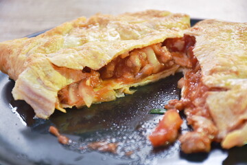 fried mashed pork with tomato and onion stuffed in Thai egg omelets on dish