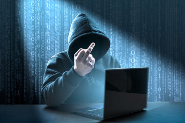faceless hooded hacker showing middle finger gesture meaning of fuck. Computer hacker in hoodie....