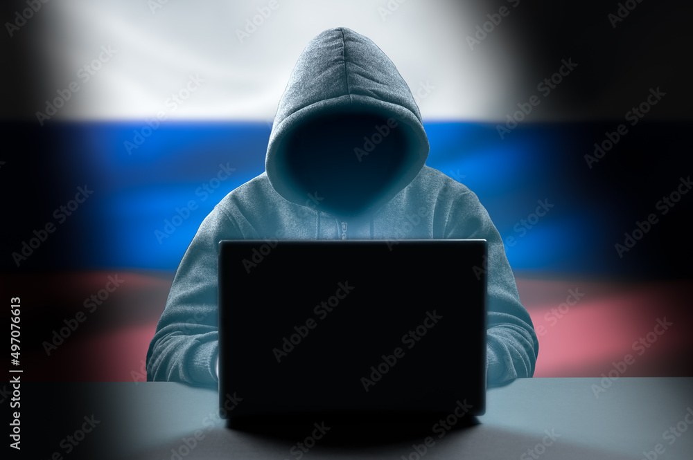 Poster faceless hooded anonymous russian hacker on russian flag background. anonymous person in hood sittin