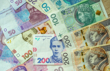 Fototapeta na wymiar Paper money, Ukrainian hryvnia and Polish zloty. Currency exchange for refugees and emigrants from Ukraine.