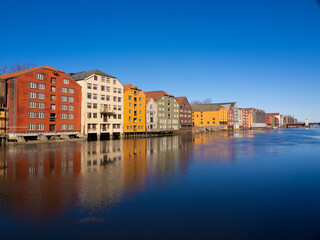 Fototapeta na wymiar The ancient warehouses flanking both sides of the Nidelva river in the old town of Trondheim, Trøndelag, Norway