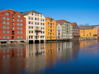 The ancient warehouses flanking both sides of the Nidelva river in the old town of Trondheim, Trøndelag, Norway