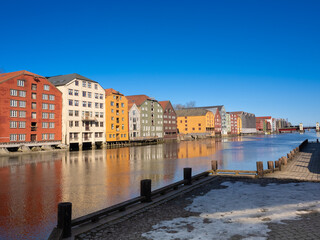 The ancient warehouses flanking both sides of the Nidelva river in the old town of Trondheim, Trøndelag, Norway