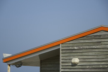Orange gable of wooden beach hut at the North Sea on a sunny day (horizontal), Zandvoort, North Holland, Netherlands - obrazy, fototapety, plakaty