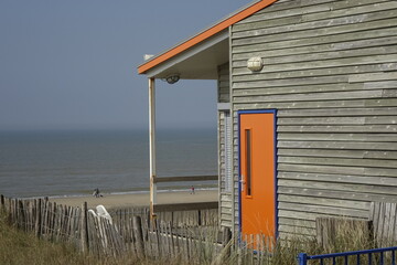 Wooden beach hut with orange door and gable an North Sea view (horizontal), Zandvoort, North...