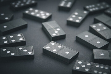 Black dominoes on dark table background