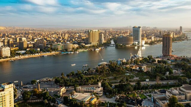 Top view of modern Cairo, river Nile, island Gezira. Timelapse. Daily life in capital of Egypt with buildings, trees, skyscrapers, cars, boats. Transport moving, ships sailing, people going